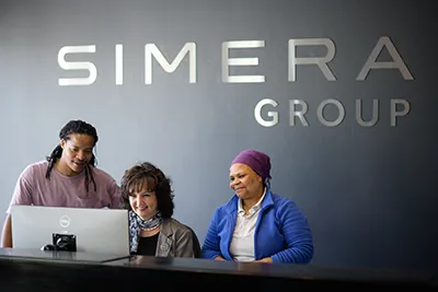 Simera Sense employees working together smiling